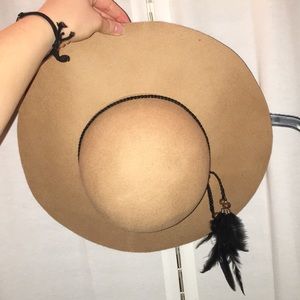 wide rimmed hat with feather